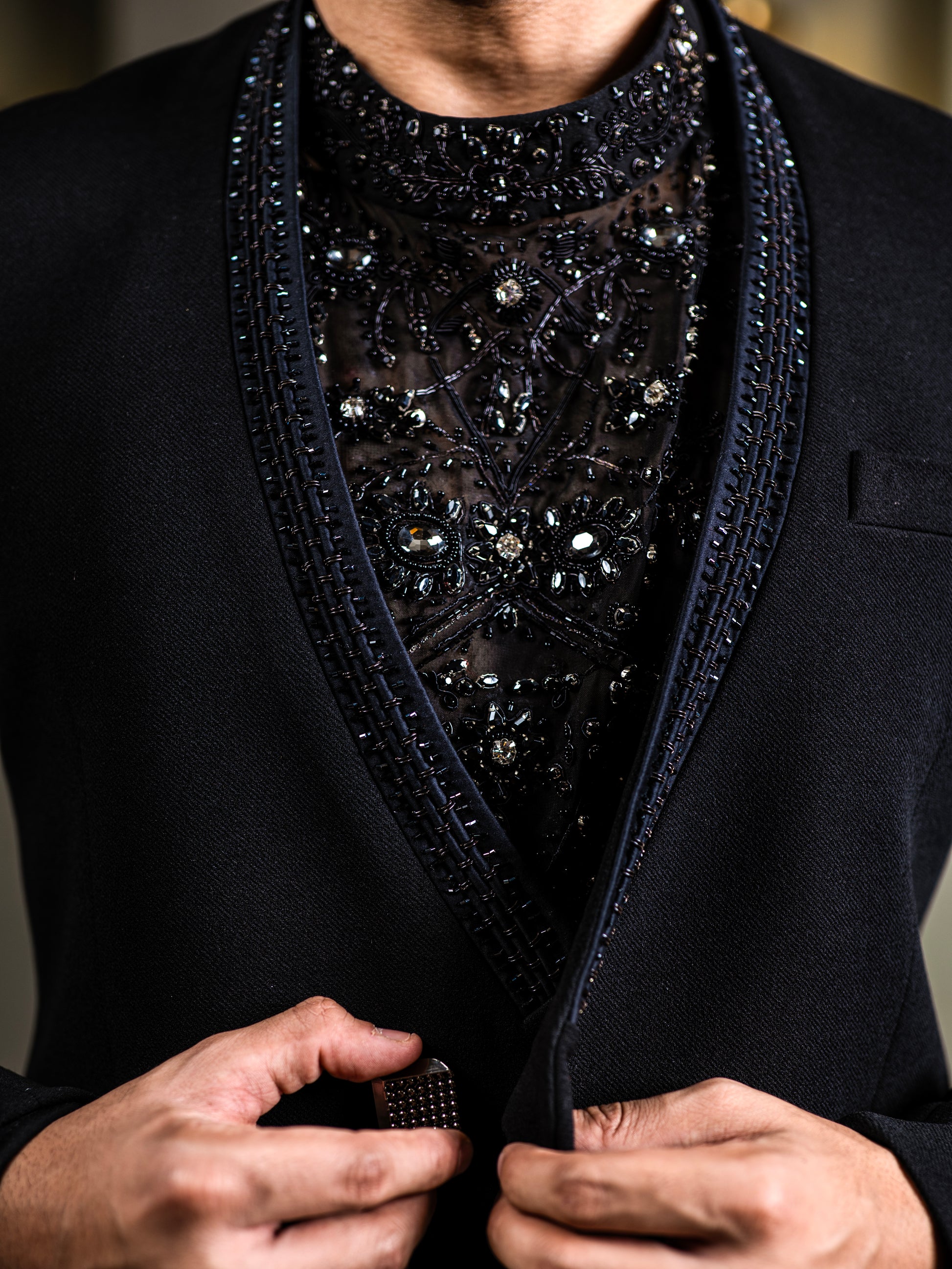 Close-up of embellished black Indo-western tuxedo for Indian groom – crystal hand embroidery on sheer fabric