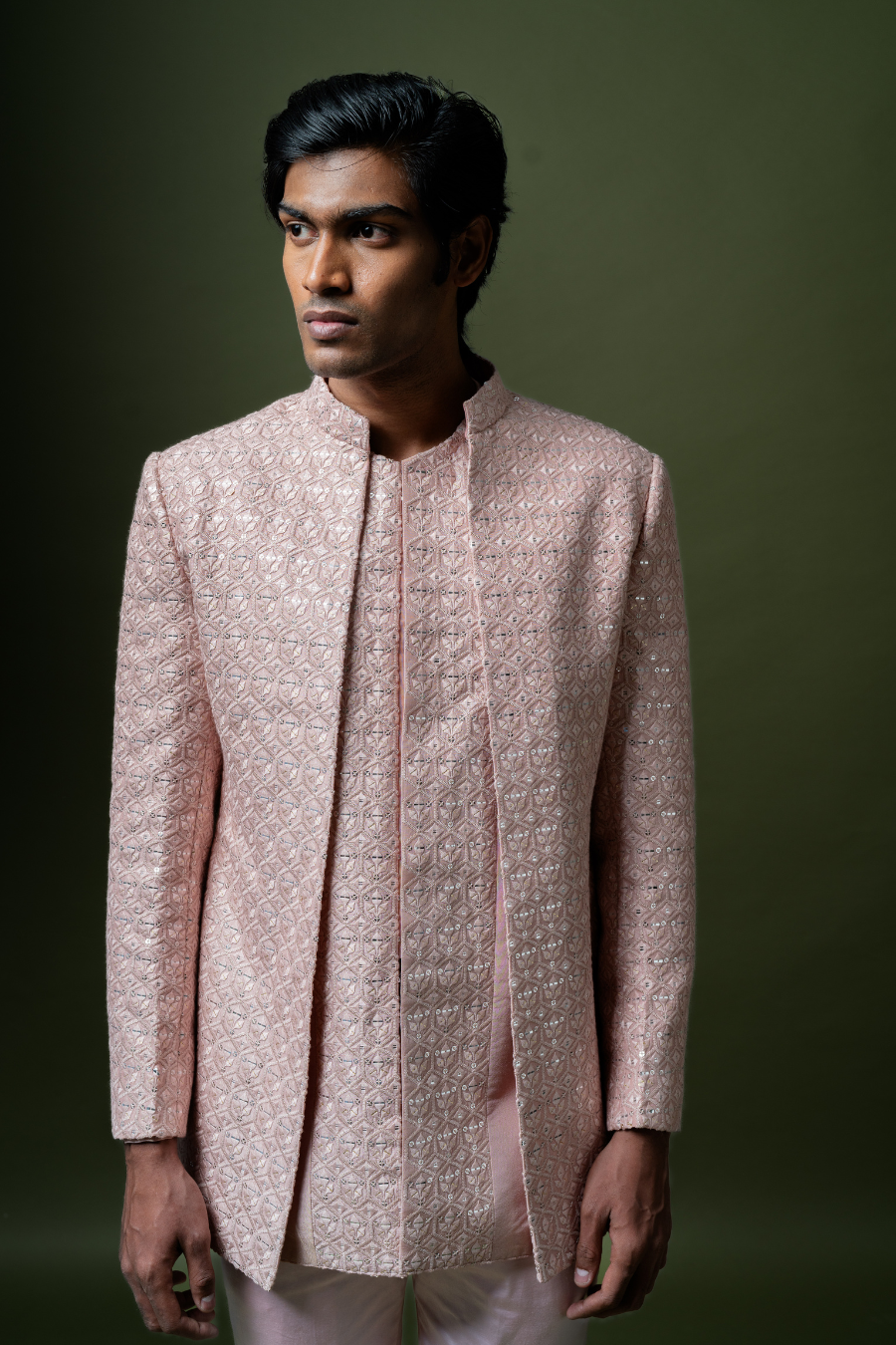 Groom dressed in blush pink embroidered Jodhpuri suit, ideal for weddings and pellikoduku ceremonies.