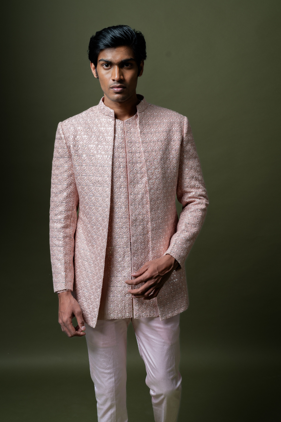 Man in a graceful blush pink Jodhpuri suit perfect for pre-wedding rituals like haldi or mehendi.