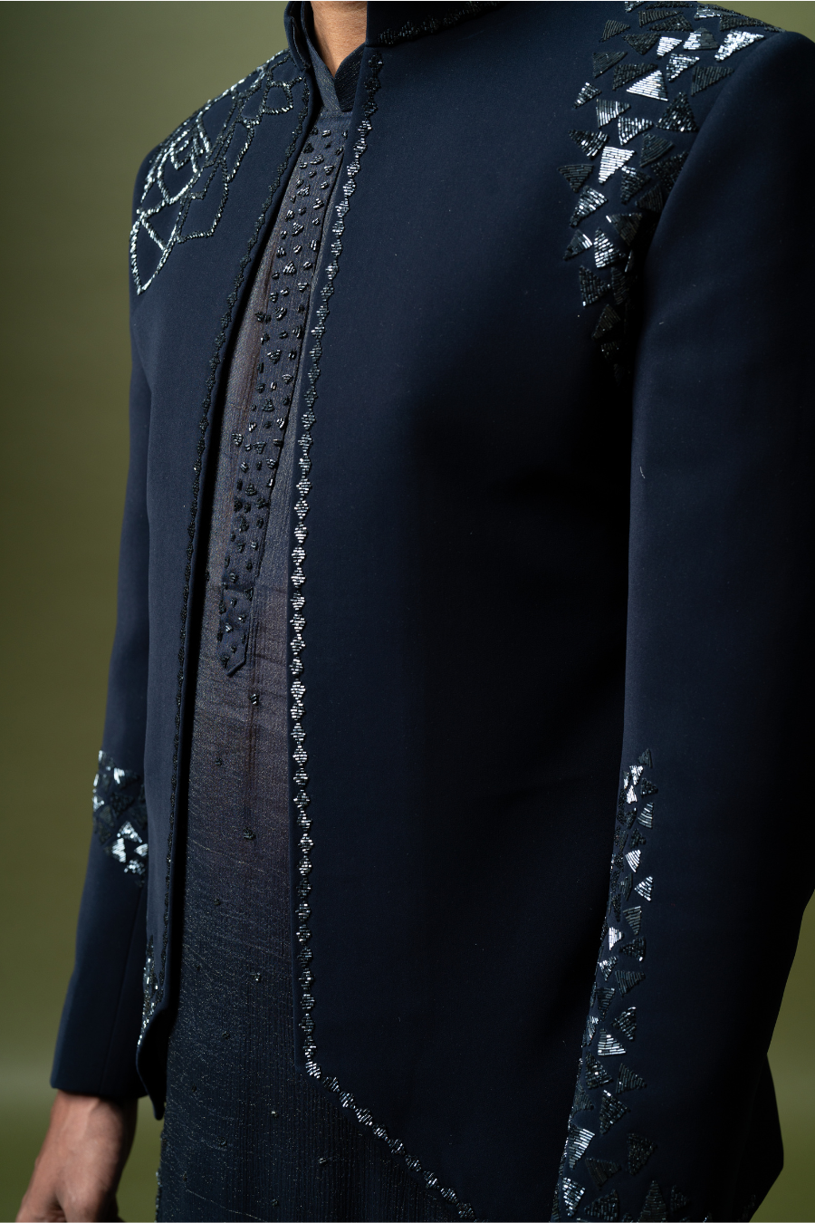 Model wearing a dark navy Jodhpuri suit with subtle embroidery, styled for South Indian grooms.