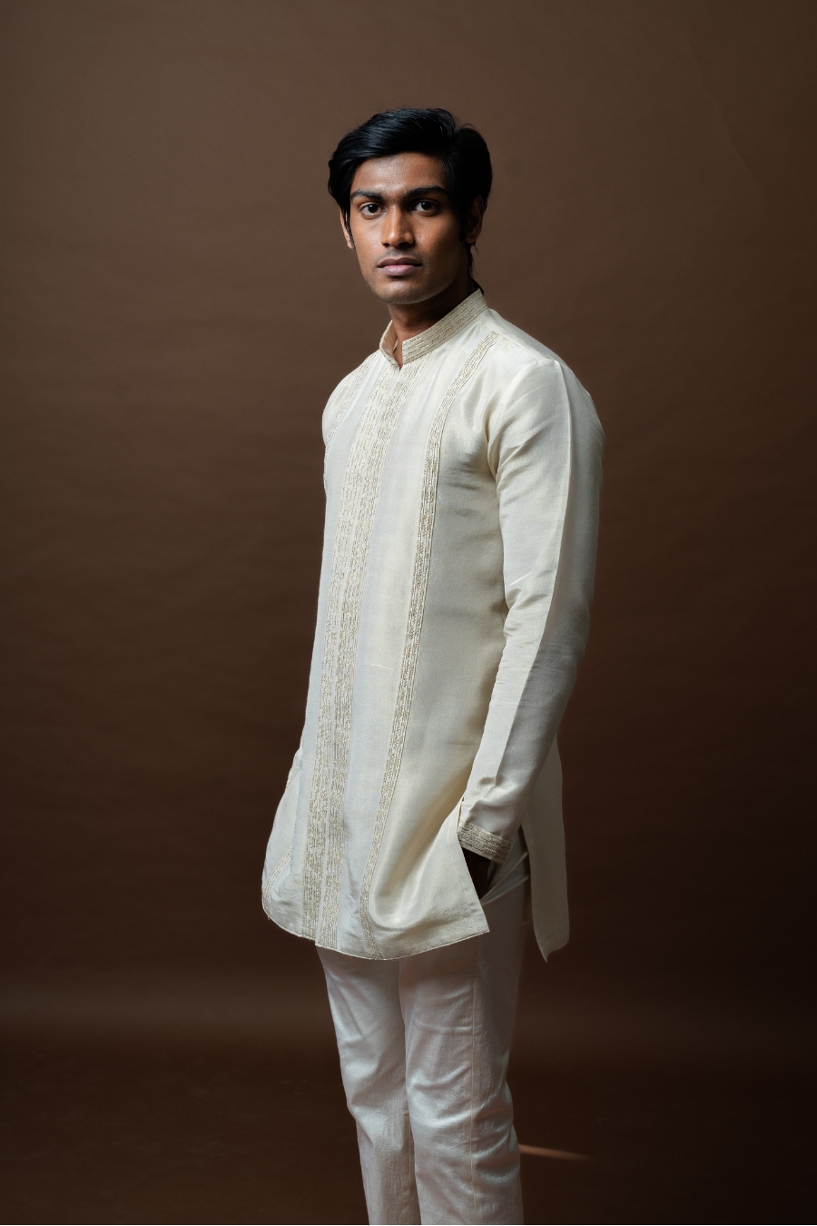 Groom model in ivory embroidered Jodhpuri suit, perfect for traditional South Indian wedding attire.