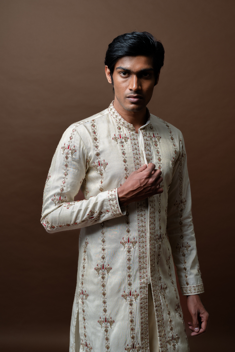 This ivory ethnic set is ideal for receptions and festive wear. The kurta’s minimal embroidery paired with a structured dhoti creates a modern regal statement.