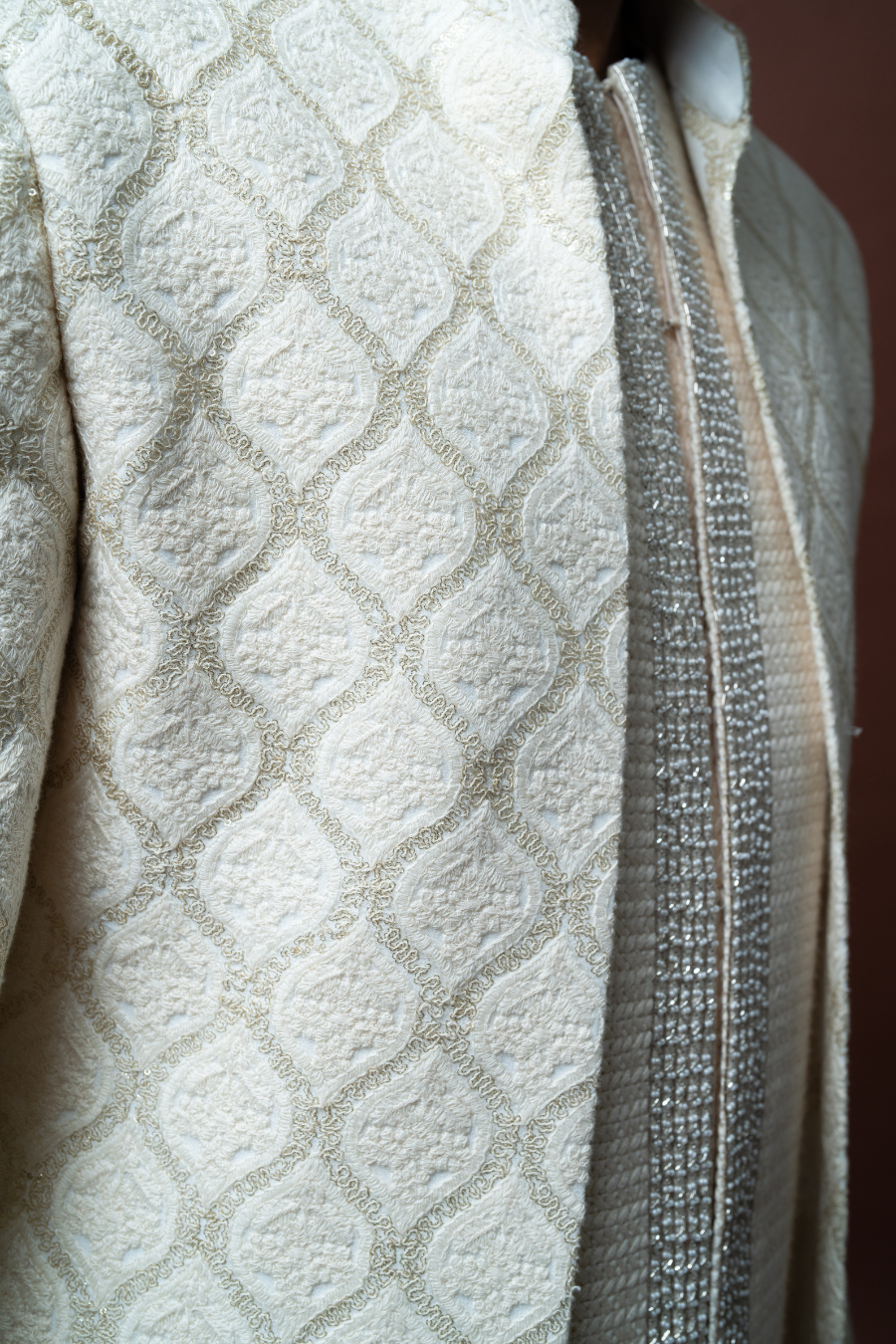 Male model in ivory Jodhpuri outfit with self-textured pattern, styled for muhurtham or pellikoduku function.