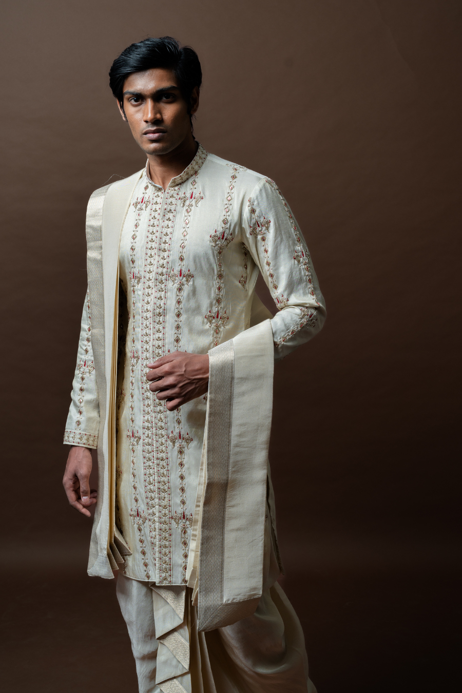 Celebrate tradition in style with this ivory embroidered kurta, paired with a structured dhoti and stole—perfect for South Indian grooms at Muhurtham or Pellikoduku.