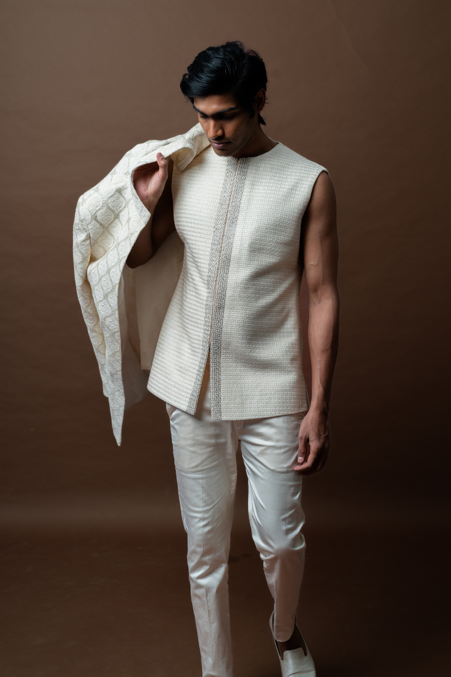 Man dressed in an elegant ivory Jodhpuri suit with a classic texture, ideal for weddings and special occasions in Hyderabad.