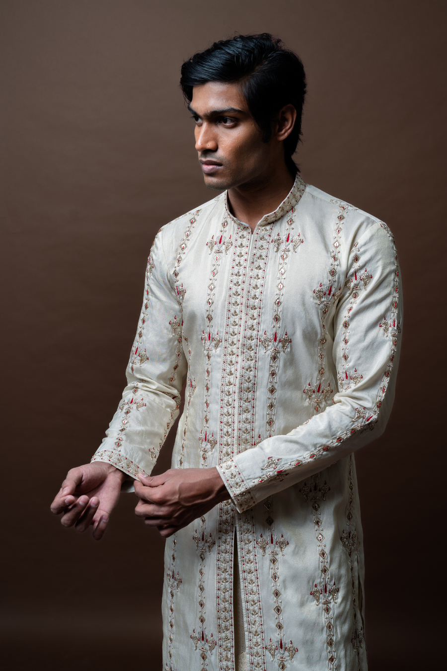 A stunning outfit for special occasions, this ivory kurta set showcases timeless embroidery with a gold-accented dupatta. Perfect for grooms and ethnic events.