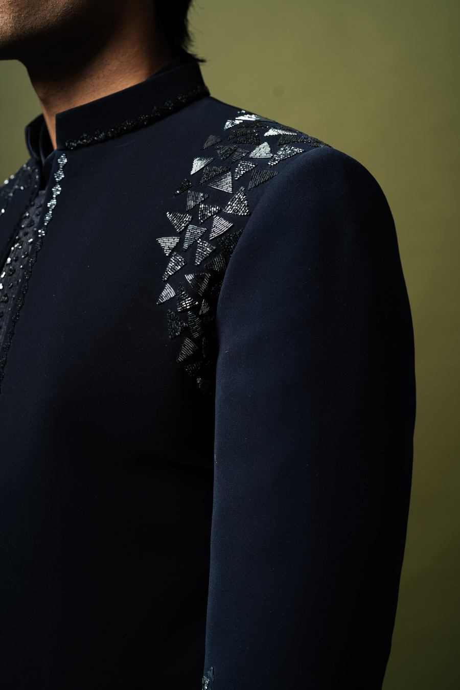 Man wearing formal embroidered Jodhpuri suit in navy, perfect for elegant wedding or engagement functions.