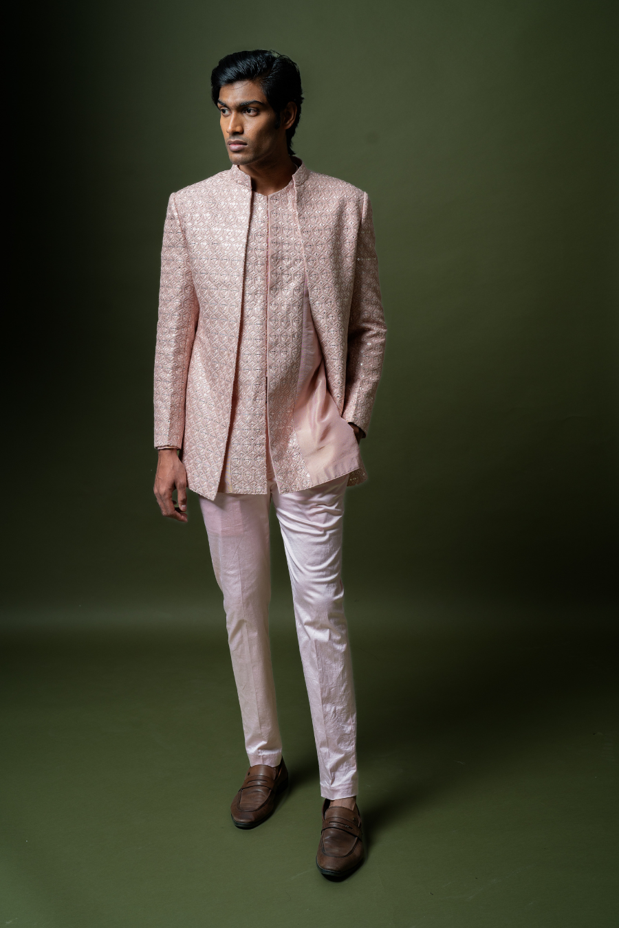 Blush pink wedding Jodhpuri suit with clean tailoring and subtle detailing, modeled by a groom.