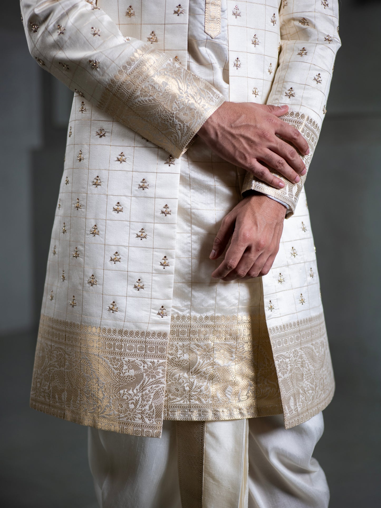 Close-up of gold zari embroidery on ivory pattu sherwani for groom – traditional South Indian wedding outfit Hyderabad
