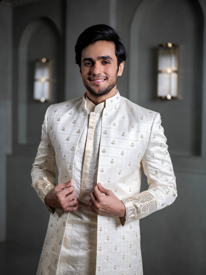South Indian groom smiling in elegant ivory pattu sherwani with intricate embroidery for wedding in Hyderabad