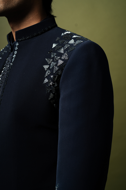Man wearing formal embroidered Jodhpuri suit in navy, perfect for elegant wedding or engagement functions.

