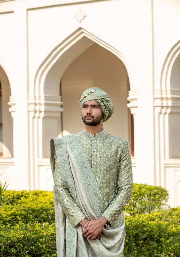 South Indian groom dressed in pastel sage green hand-embroidered Pattu Sherwani with matching dupatta and turban, perfect for wedding, Muhurtham, and Pellikoduku in Hyderabad.